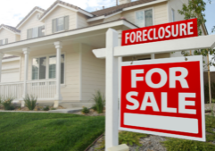 foreclosure for sale sign in front of house